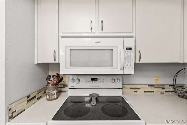 1631 N Dalary Pt, Crystal River, FL 34429 - kitchen with white appliances, decorative backsplash, light countertops, and white cabinets