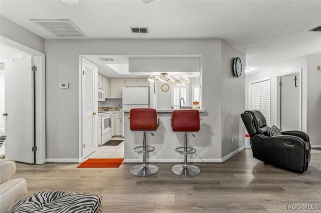 1631 N Dalary Pt, Crystal River, FL 34429 - living area with light wood-type flooring, baseboards, and plenty of natural light