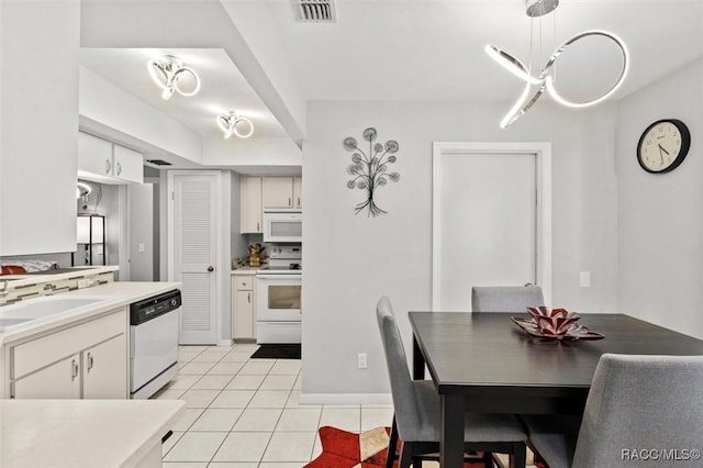 1631 N Dalary Pt, Crystal River, FL 34429 - kitchen with white appliances, a sink, light tile patterned floors, and white cabinetry