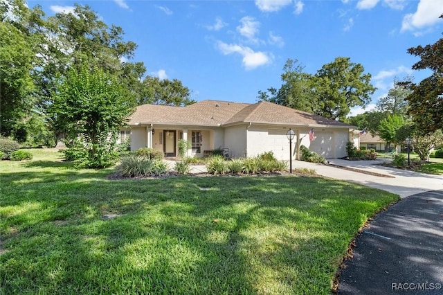 1631 N Dalary Pt, Crystal River, FL 34429 - single story home featuring driveway, a front yard, an attached garage, and stucco siding