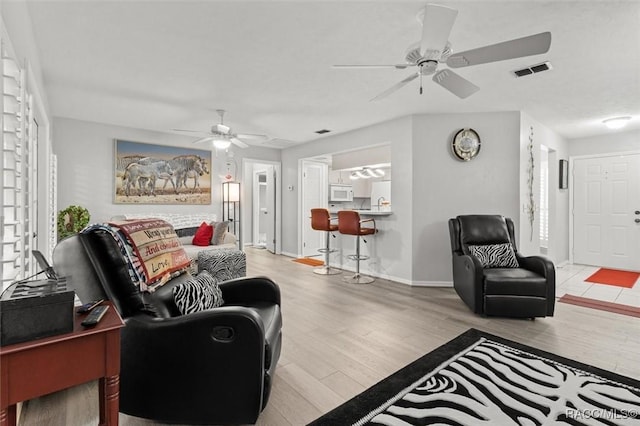 1631 N Dalary Pt, Crystal River, FL 34429 - living room featuring ceiling fan, wood finished floors, and baseboards