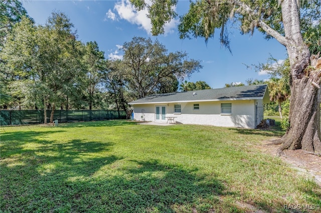 back of house with a lawn