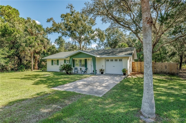 ranch-style house with covered porch, a garage, and a front yard