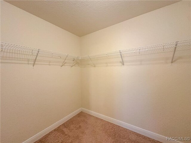 bathroom featuring tile patterned flooring, vanity, a textured ceiling, and walk in shower