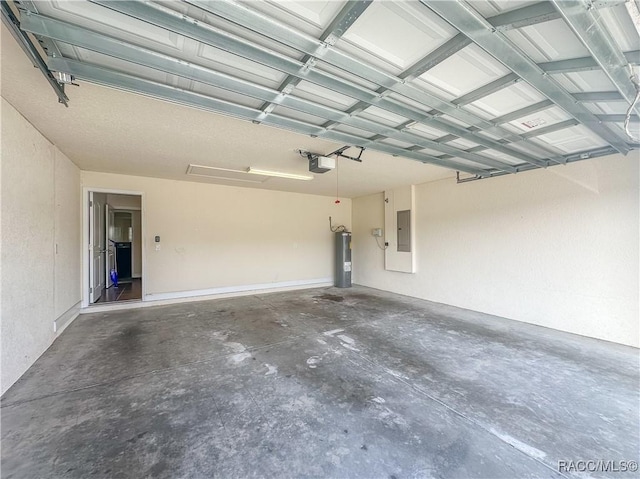 garage featuring a garage door opener, electric panel, and water heater