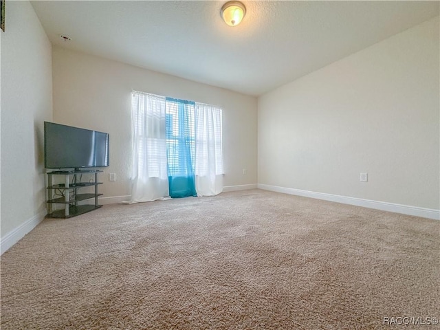 empty room with carpet and baseboards