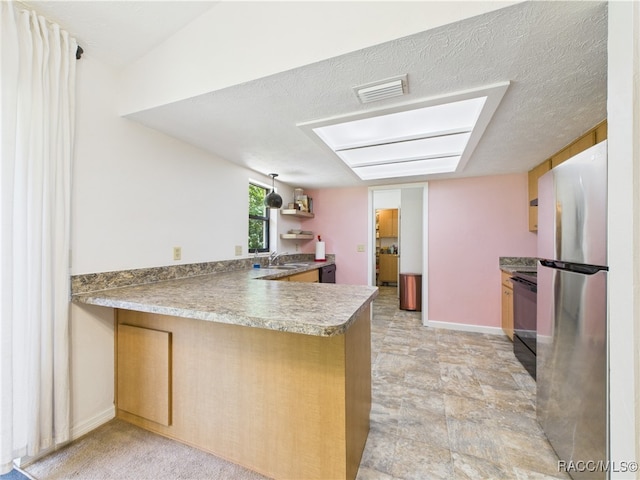 896 N Hollywood Cir, Crystal River, FL 34429 - kitchen with freestanding refrigerator, a sink, a peninsula, black range with electric stovetop, and brown cabinetry