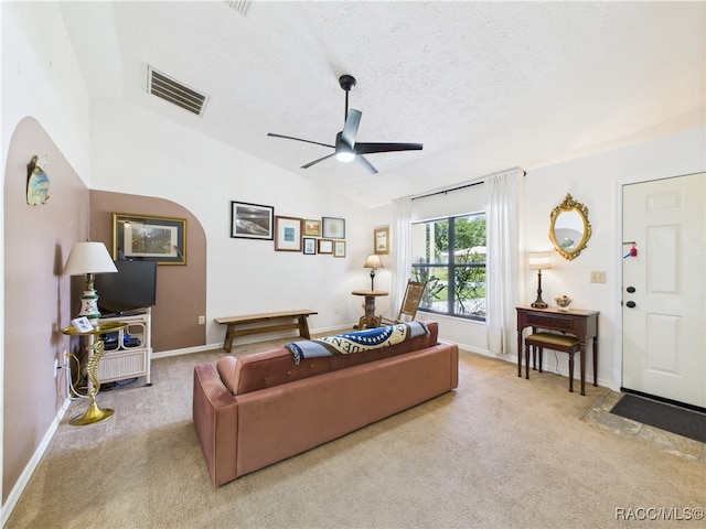 896 N Hollywood Cir, Crystal River, FL 34429 - carpeted living room with a ceiling fan, vaulted ceiling, a textured ceiling, and baseboards