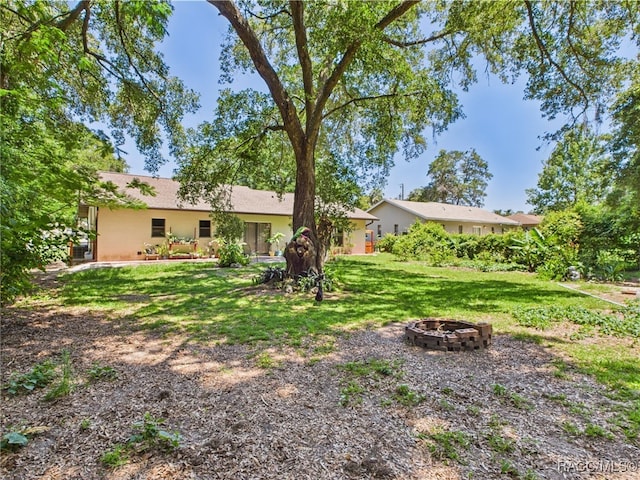 896 N Hollywood Cir, Crystal River, FL 34429 - view of green lawn with an outdoor fire pit