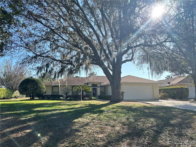 ranch-style home featuring concrete driveway, a front lawn, an attached garage, and stucco siding