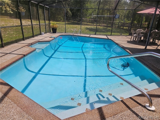 view of pool featuring a lanai and a patio