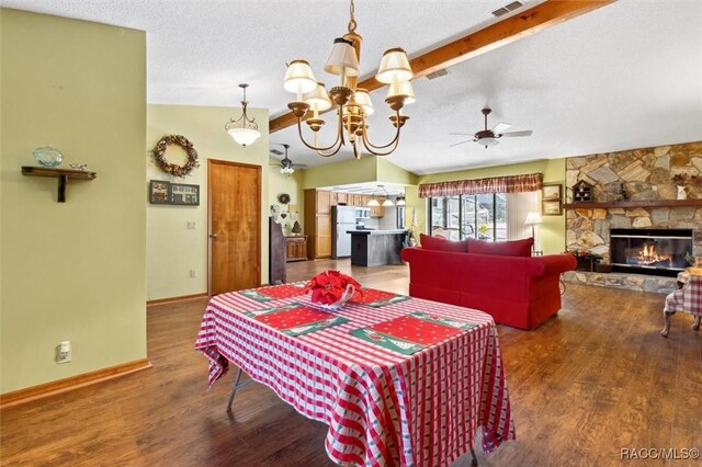 kitchen featuring stainless steel refrigerator, kitchen peninsula, dark wood-type flooring, pendant lighting, and sink