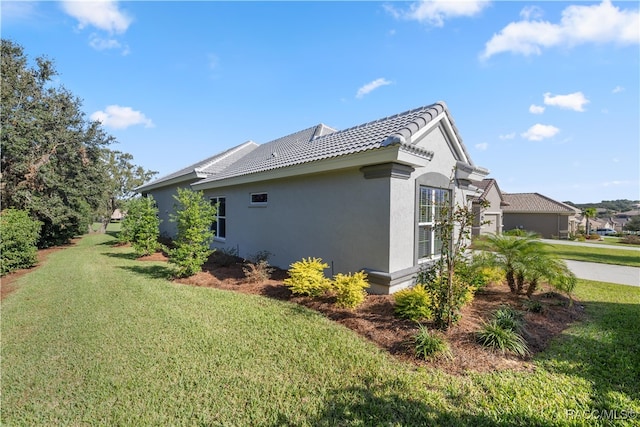 view of side of home featuring a yard