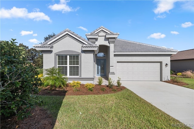 view of front of house with a garage and a front yard