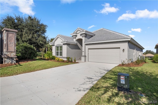 view of front of house featuring a garage and a front yard