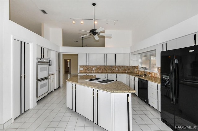 kitchen with black appliances, white cabinetry, sink, backsplash, and ceiling fan