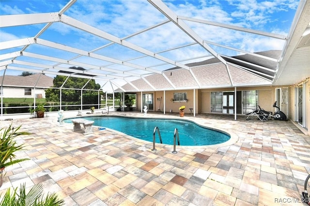 view of pool featuring a patio area and glass enclosure