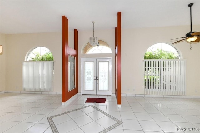 entrance foyer featuring ceiling fan, light tile patterned floors, and french doors