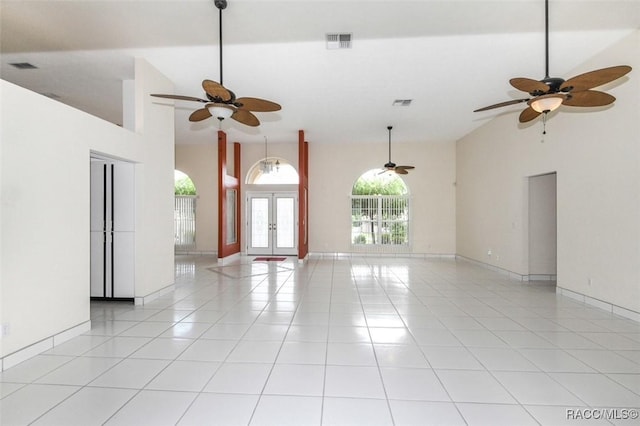 empty room with light tile patterned floors and french doors