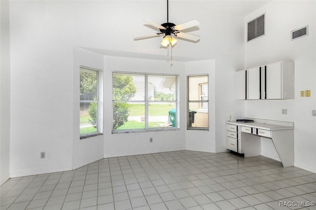 kitchen with ceiling fan, light tile patterned flooring, and white cabinets