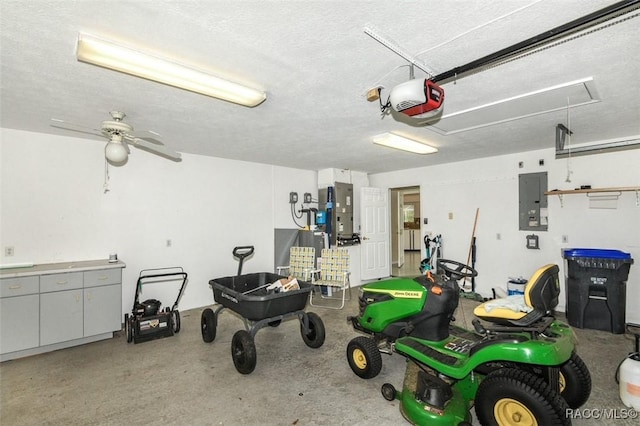 garage featuring ceiling fan, a garage door opener, and electric panel