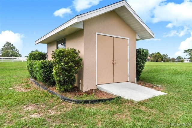 view of outbuilding with a yard