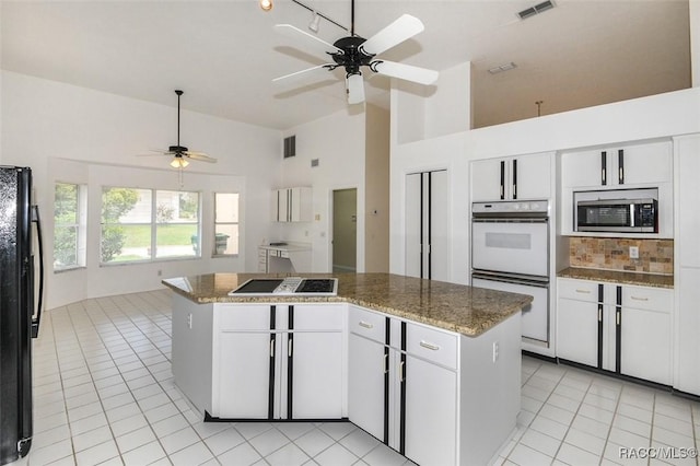 kitchen with white cabinetry, black appliances, and a kitchen island