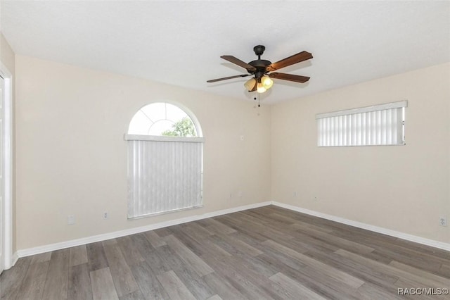 empty room with ceiling fan and hardwood / wood-style flooring