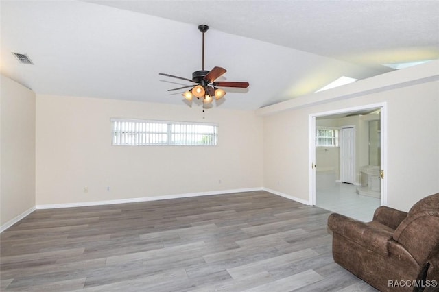 unfurnished living room with ceiling fan, hardwood / wood-style floors, and lofted ceiling