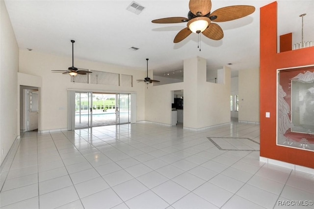 spare room with high vaulted ceiling and light tile patterned floors