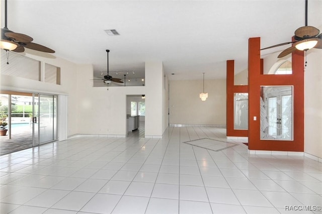 tiled spare room with french doors and a high ceiling