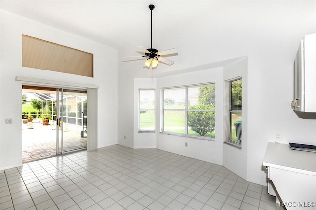 unfurnished living room featuring ceiling fan and light tile patterned flooring