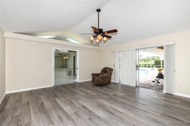 unfurnished room with ceiling fan, hardwood / wood-style flooring, and lofted ceiling