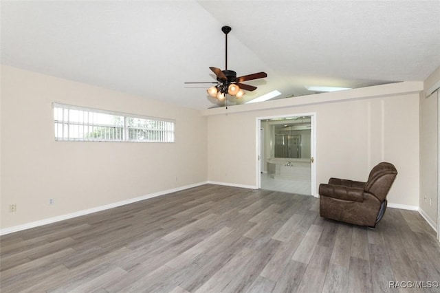 unfurnished room with lofted ceiling, ceiling fan, and hardwood / wood-style flooring