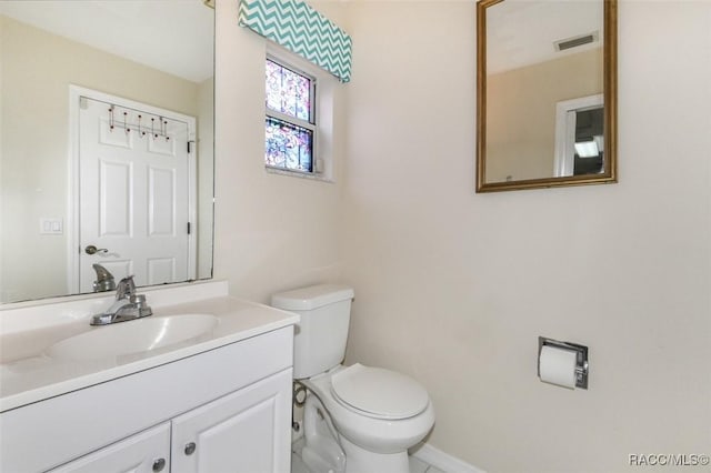 bathroom featuring toilet and vanity