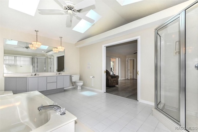 full bathroom with toilet, vanity, tile patterned flooring, lofted ceiling with skylight, and shower with separate bathtub