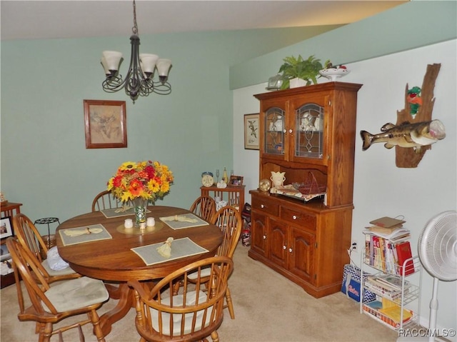 carpeted dining room with a chandelier