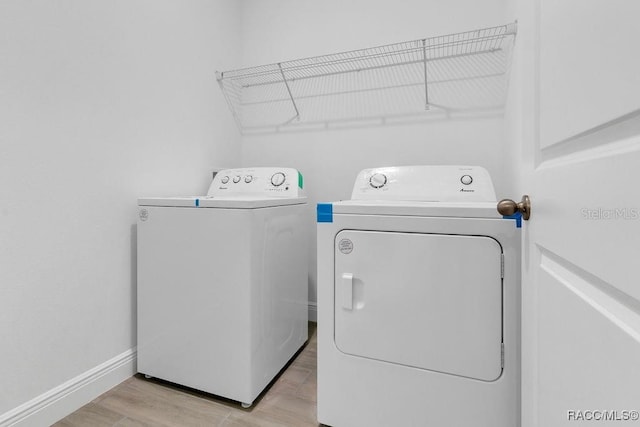 laundry area featuring light wood-type flooring and independent washer and dryer