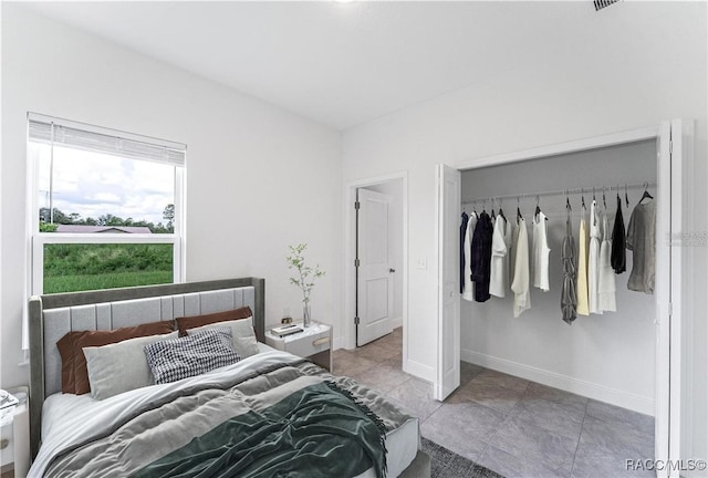 bedroom with light tile patterned flooring and a closet