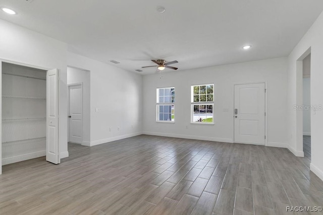 interior space with ceiling fan and light hardwood / wood-style floors