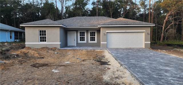 ranch-style home featuring a garage