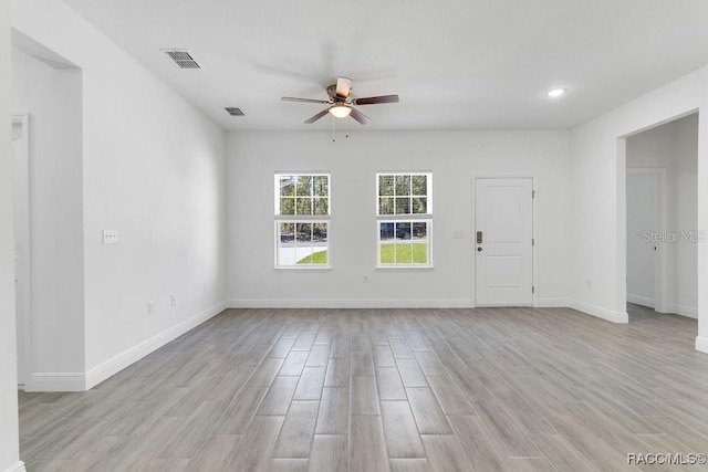 empty room featuring light hardwood / wood-style flooring and ceiling fan