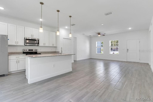 kitchen featuring appliances with stainless steel finishes, decorative light fixtures, white cabinetry, and ceiling fan