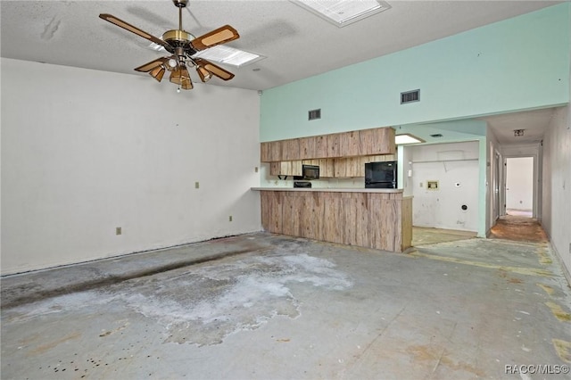 kitchen with a textured ceiling, black appliances, kitchen peninsula, and ceiling fan