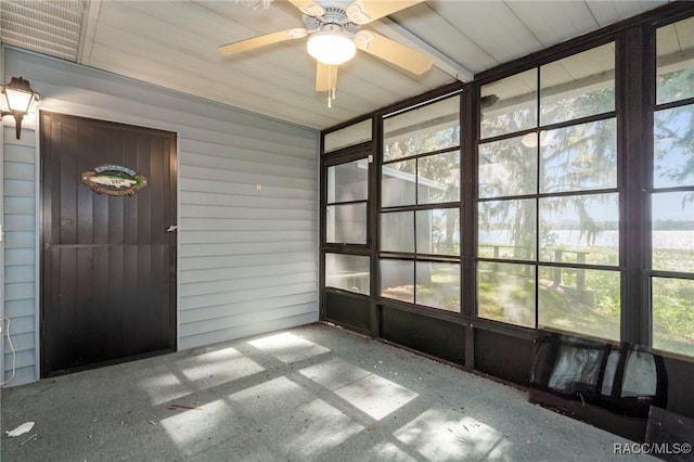 unfurnished sunroom featuring ceiling fan