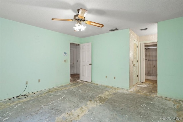 unfurnished bedroom with concrete flooring, a textured ceiling, ceiling fan, and a closet