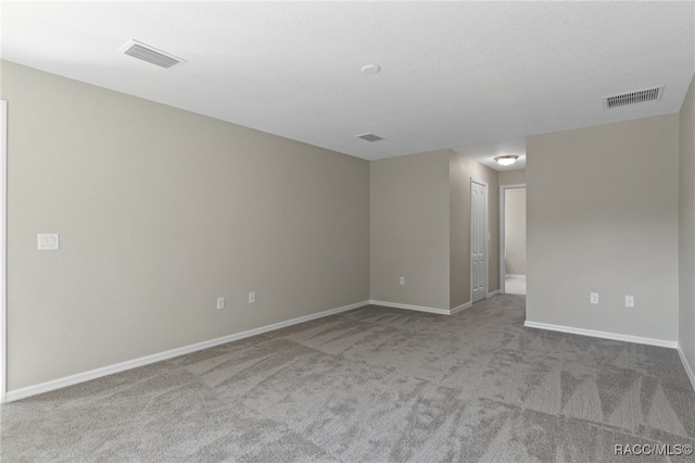 unfurnished room featuring light carpet