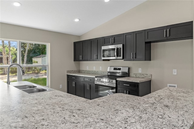 kitchen featuring sink, lofted ceiling, and stainless steel appliances