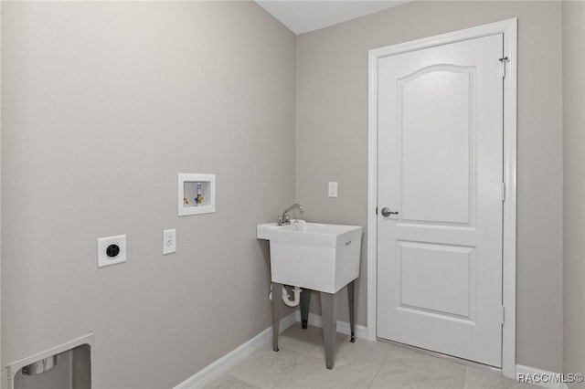 washroom featuring hookup for an electric dryer, washer hookup, and light tile patterned floors