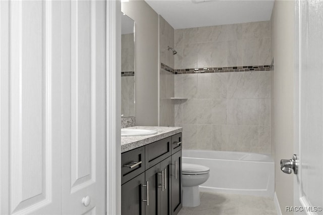 full bathroom featuring vanity, tiled shower / bath combo, and toilet